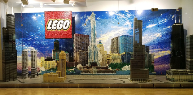 Lego-Kreationen auf einem Boden mit einer Wand im Hintergrund.